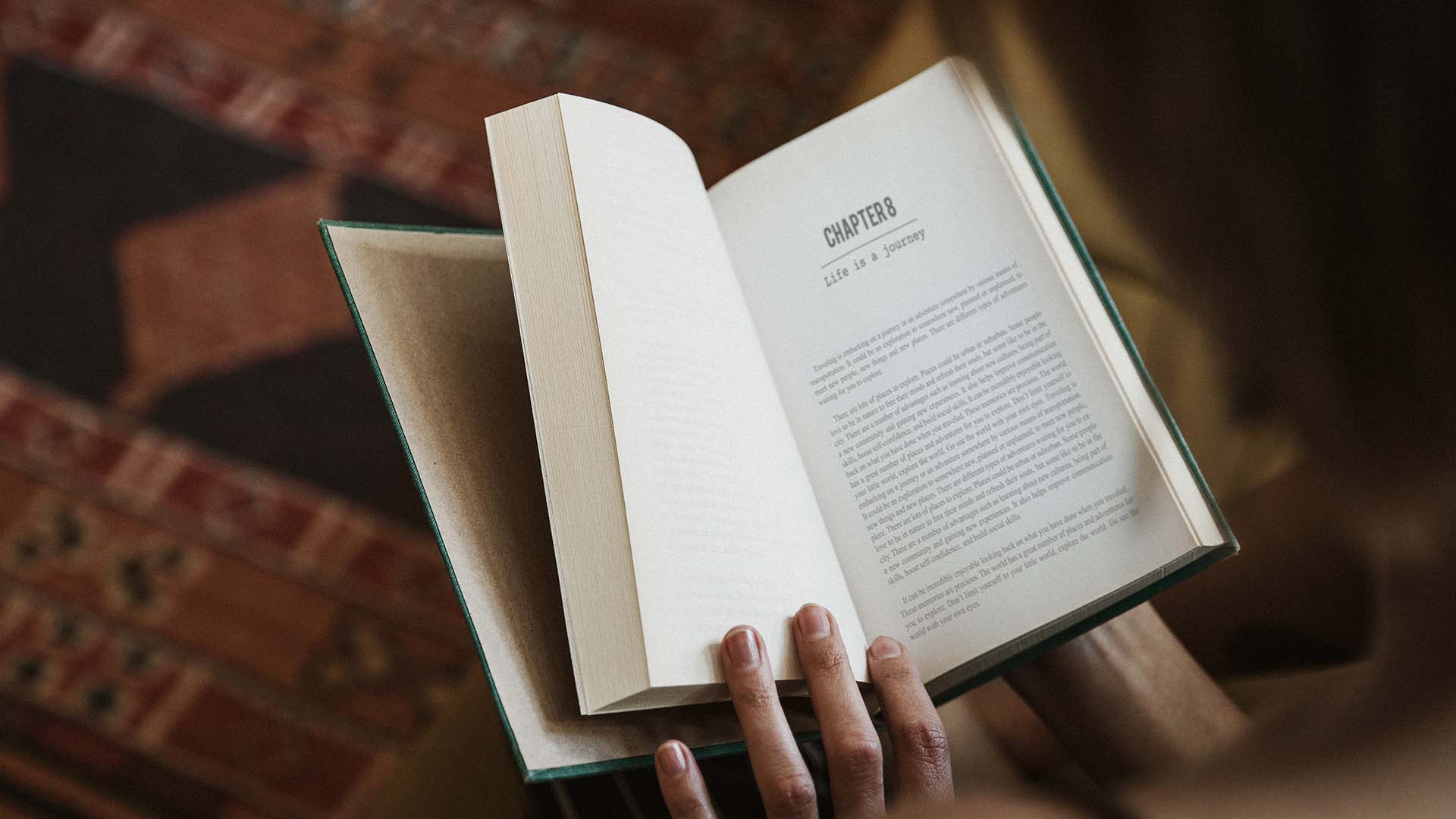 Woman reading a book in her living room